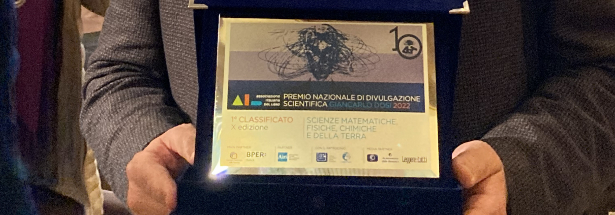 Marco Andreatta mostra il premio per la divulgazione scientifica "Dosi" per l'area matematica